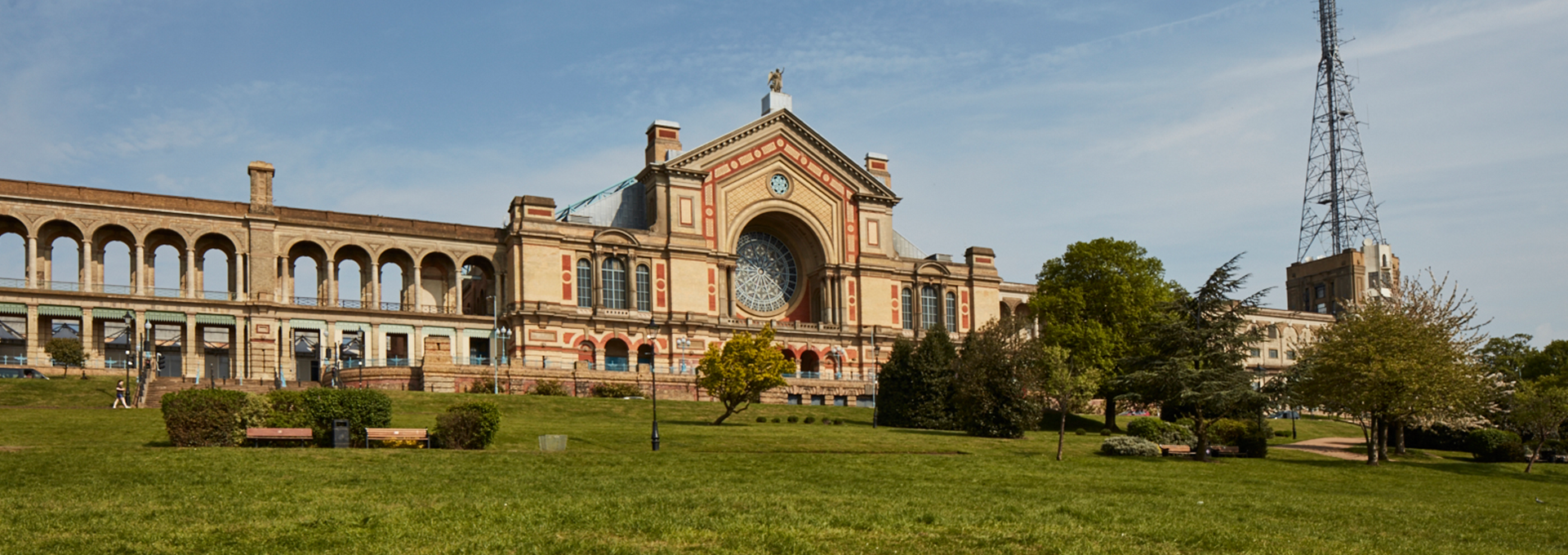 View of Alexandra Palace from below on a sunny day with a blue sky.