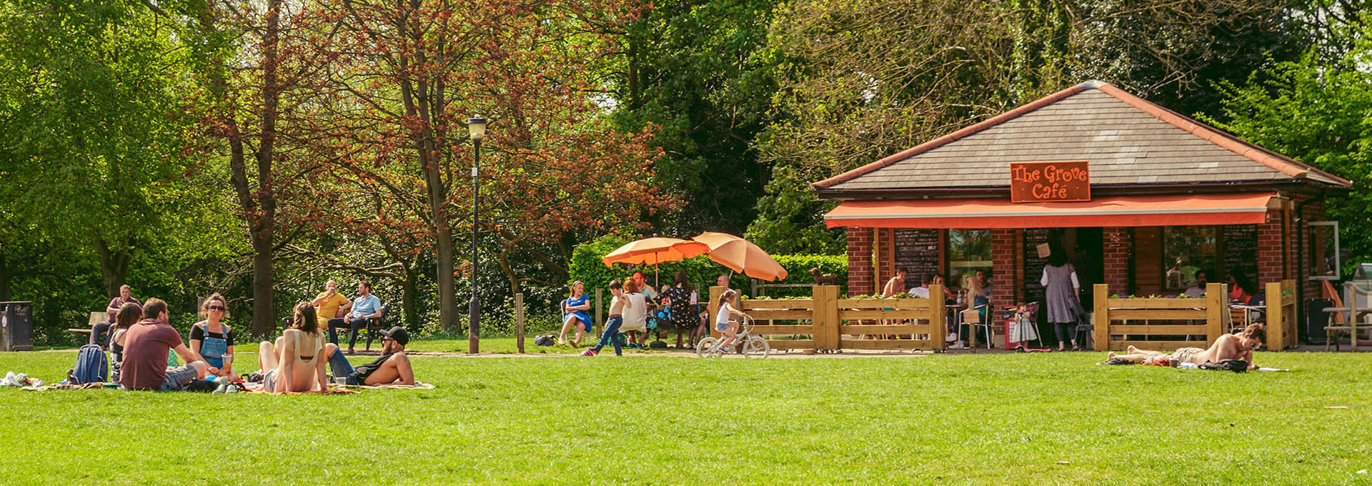 People picnicking on the grass outside of the Grove cafe.